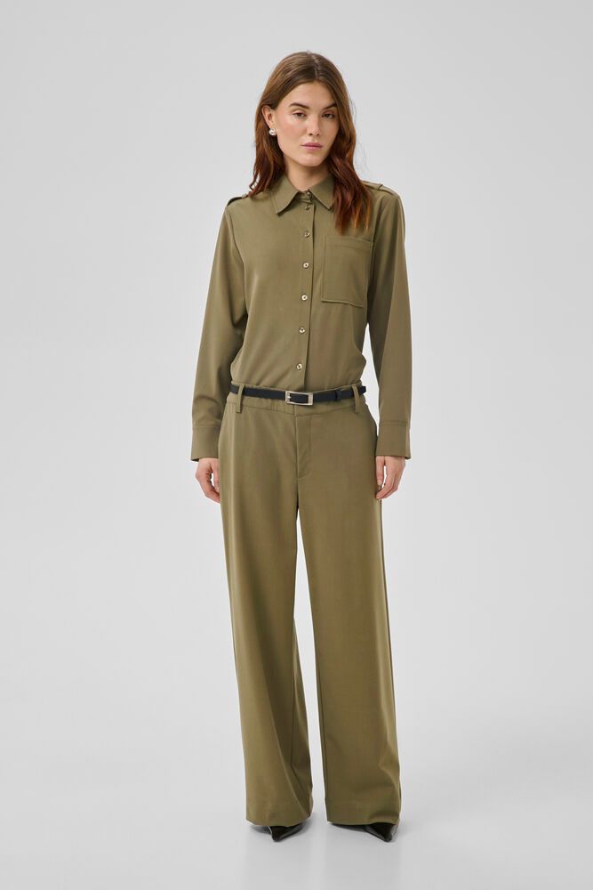 Wide-leg pants feature a tailored fit and crisp appearance with a straight waistband and subtle crease. Minimalistic details and belt loops offer a polished look, versatile for styling. Secure zipper fly with no visible pockets.